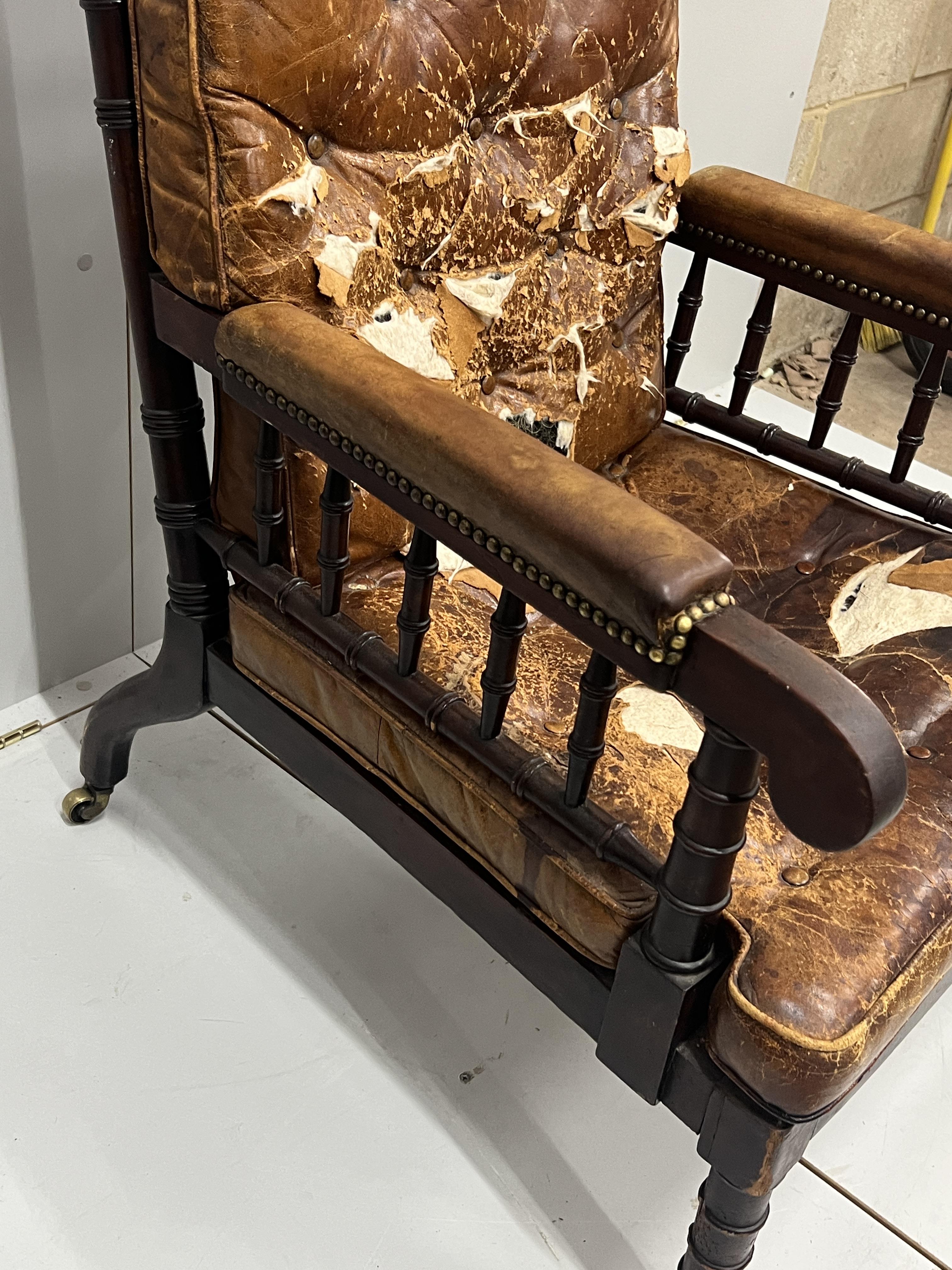 An early Victorian turned mahogany library chair with distressed leather cushion seat and back, width 62cm, depth 66cm, height 104cm